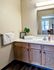 Bathroom with white countertops and wood cabinets