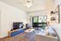 Liviing room in unit looking toward balcony