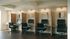 Rendering of a modern business center with sleek workstations, ergonomic chairs, and stylish wall art, perfect for productivity.
