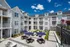 Outdoor lounge at our apartments near Tarrytown, NY, featuring outdoor couches, umbrellas, and a view of the apartments.