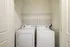 The laundry room at our apartments in Ossining, featuring wood grain floor paneling and in-home washer and dryer.