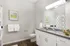 Model bathroom at our apartments in Marlborough, featuring wood grain floor paneling and granite patterned countertops.
