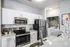 Model kitchen at our apartments in Charlotte, NC, featuring white countertops and stainless steel appliances.