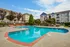 The pool area at our apartments in Charlotte, NC, featuring beach chairs, outdoor couches, and grill stations.