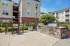 Outdoor lounge at our apartments in Charlotte, featuring outdoor seating, a grill station, and view of the apartments.