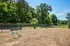 The dog park at our apartments in Charlotte, NC, featuring a fenced-in wood chip area with obstacles for dogs.