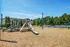The playground at our apartments in Charlotte, NC, featuring a play structure with wood chips and a view of the apartments.