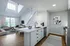 Model kitchen at our apartments in Ossining, featuring wood grain floor paneling and stainless steel appliances.