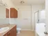Model bathroom at our apartments in Marlborough, featuring tan tile floor paneling and a shower and bath.