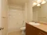 Marlborough MA apartment bathroom with tiled floors and wooden cabinetry.