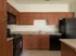 Marlborough MA apartment kitchen with tiled floor and wooden cabinetry.