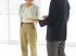 two people talking and pointing to folder