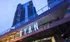The entrance to the Cyan on Peachtree apartment complex in Atlanta, GA, featuring a lit up sign above the entrance.