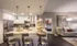 Model kitchen at our apartments for rent in Atlanta, featuring counter seating and a view of the bedroom.