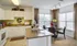 Pembroke apartment kitchen with white wood cabinetry and a view of the dining space.