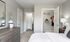 Model bedroom at our apartments in Pembroke, featuring carpeted floors and a view of the walk in closet.