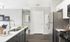 Pembroke MA apartment kitchen with dark wood cabinetry.