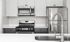 Close up of a luxury Pembroke MA apartment kitchen with sleek white surfaces.