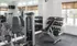 Pembroke Woods apartments fitness center with weights and exercise machines for residents to use.