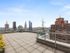 Rooftop lounge at our apartments for rent in Flatiron, featuring a view of the New York skyscrapers and high rises.