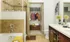 Luxury Denver apartment bathroom with tiled flooring, dark cabinetry and a walk-in shower.