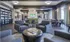 Resident lounge at our apartments for rent in Sandy Springs, featuring cushioned chairs, flat screen TV, and elegant decor.