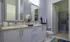 Model bathroom at our apartments for rent in Sandy Springs, featuring lavender walls and a view of the walk in closet.