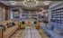 Lounge at our apartments in Sandy Springs, featuring carpeted floors, couches, and books on shelves.