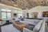 Pembroke Woods apartments' community lounge with a large grey sectional sofa in the center.