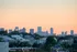 Photograph of the skyline of Revere, featuring a sunset, skyscrapers, trees, and a view of the city of Revere, MA.