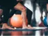 Stock photograph of people exercising; they are doing yoga or aerobics, and only their legs are visible.