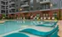 Pool area at our apartments in Sandy Springs, featuring pool chairs, a shaded area, and reclining beach chairs.