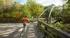 Photograph of someone running across a wooden foot bridge in the woods. The person is wearing athletic attire.Someone running across a footbridge at our apartments for rent in WAtertown, MA, featuring trees on either side,