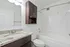 Bathroom with granite countertop and storage