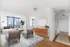 Model living room at our apartments in New York, featuring wood grain floor paneling, couches and rugs.