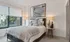 Model bedroom at our apartments in Atlanta, featuring carpeted floors, a large window, and elegant decor.