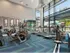 Fitness center at our apartments for rent in Atlanta, featuring treadmills, exercise bikes, and carpeted flooring.