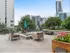 Rooftop lounge at our apartments in Atlanta, featuring cushioned outdoor chairs, a fire pit, and a view of the city.Outdoor lounge at our apartments for rent in Atlanta, featuring outdoor couches, a fire pit, and a view of the city.