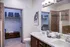 Luxury Denver apartment bathroom with tiled flooring and dark cabinetry.