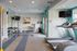 Avia Lowry's fitness center equipped with exercise machines, weights and a television.