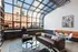 The lounge at our apartments in Chelsea, featuring wood grain floor paneling and glass ceiling panes.