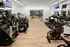 The fitness center at our apartments in Chelsea, featuring wood grain floor paneling and an array of exercise machines.
