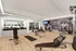The fitness center at our apartments in Midtown Manhattan, featuring wood grain floor paneling and free weights.