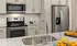 Model kitchen at our apartments in Atlanta, GA, featuring granite countertops and stainless steel appliances.