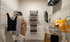 Model walk-in closet at our apartments in Atlanta, featuring clothes racks with baskets and clothes hanging.