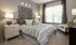Model bedroom at our apartments for rent in Atlanta, featuring carpeted flooring and windows with blinds.