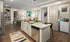 Model kitchen at our apartments in Atlanta, GA, featuring wood grain floor paneling and granite counter tops.