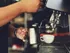 Someone steaming milk using an espresso machine at a cafe near our apartments for rent in Atlanta, GA.
