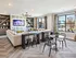 Clubroom at our apartments in Atlanta, featuring carpeted floors, large windows, and a flat screen TV.