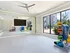 The fitness center at our apartments in Atlanta, featuring an aerobics room with weight balls and a TV.